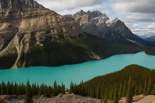 Breathtaking Mountain Landscape at Hot Springs National Park Scenic view of turquoise Peyto Lake surrounded by forested mountains under a partly cloudy sky near Hot Springs National Park.