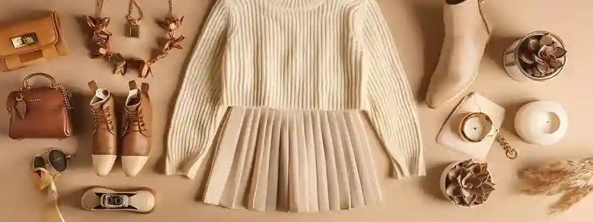 Flat lay of affordable fall clothes for women, including a cream ribbed sweater, camel faux leather skirt, tan ankle boots, and gold accessories styled on a beige background for a chic, designer-inspired autumn look. Flat lay of affordable fall clothes for women, including a cream ribbed sweater, camel faux leather skirt, tan ankle boots, and gold accessories styled on a beige background for a chic, designer-inspired autumn look.